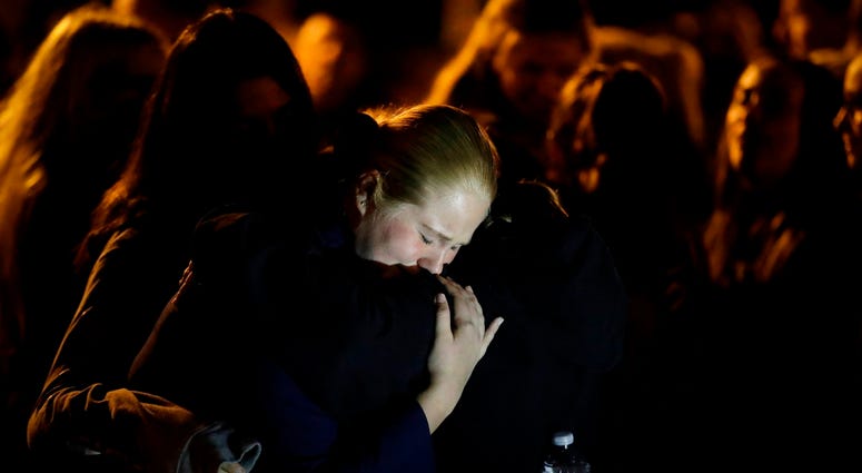 Students embrace during a vigil at Central Park in the aftermath of a shooting at Saugus High School Thursday, Nov. 14, 2019, in Santa Clarita, Calif. Saugus students embrace