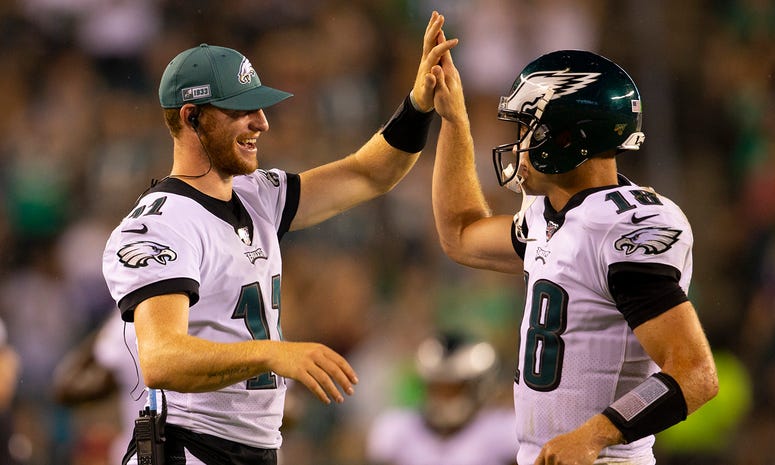 Carson Wentz #11 of the Philadelphia Eagles high fives Josh McCown #18 after McCown threw a touchdown pass in the third quarter against the Baltimore Ravens in the preseason game at Lincoln Financial Field on Aug. 22, 2019 in Philadelphia, Pennsylvania. Philadelphia Eagles