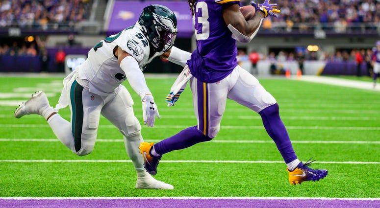 Dalvin Cook #33 of the Minnesota Vikings runs with the ball away from #52 Zach Brown for a one-yard touchdown in the fourth quarter of the game against the Philadelphia Eagles at U.S. Bank Stadium on Oct. 13, 2019 in Minneapolis, Minnesota. Eagles vs. Vikings