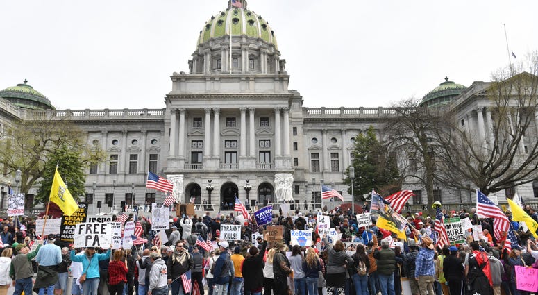 People take part in a "reopen" Pennsylvania demonstration on April 20, 2020 in Harrisburg, Pennsylvania. Harrisburg protest
