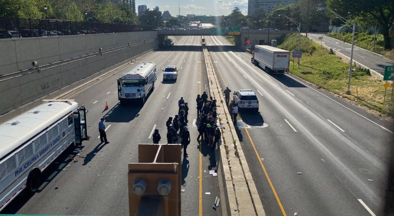 Police officers arresting protesters on the Vine Street Expressway Police officers arresting protesters on the Vine Street Expressway