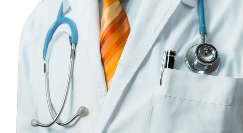 Doctor In White Medical Coat With Stethoscope. Doctor In White Medical Coat With Stethoscope.