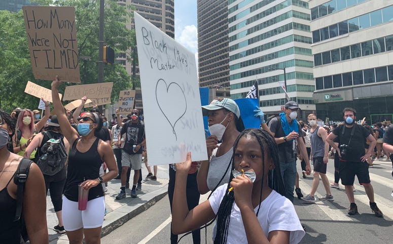 Demonstrators protest outside City Hall Saturday afternoon. Demonstrators protest outside City Hall Saturday afternoon.