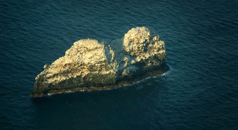 The largest volcano in the world sits beneath two small rocky peaks in Hawaii. Gardner Pinnacles appear barren but host several species of seabirds and is part of the Northwestern Hawaiian Islands, Tuesday, Dec. 13, 2005. Hawaii volcano