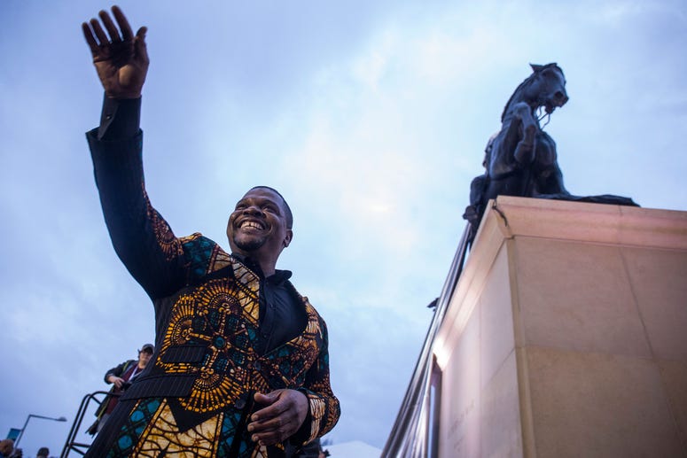 Artist Kehinde Wiley acknowledges the crowd during an unveiling ceremony for his statue, Rumors of War. Kehinde Wiley