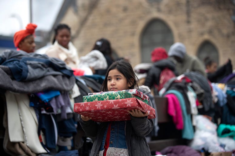 Briella Jones 5, who lived in the Francis Drake Hotel apartments with her family, holds donated Christmas presents. Briella Jones 5, who lived in the Francis Drake Hotel apartments with her family, holds donated Christmas presents.