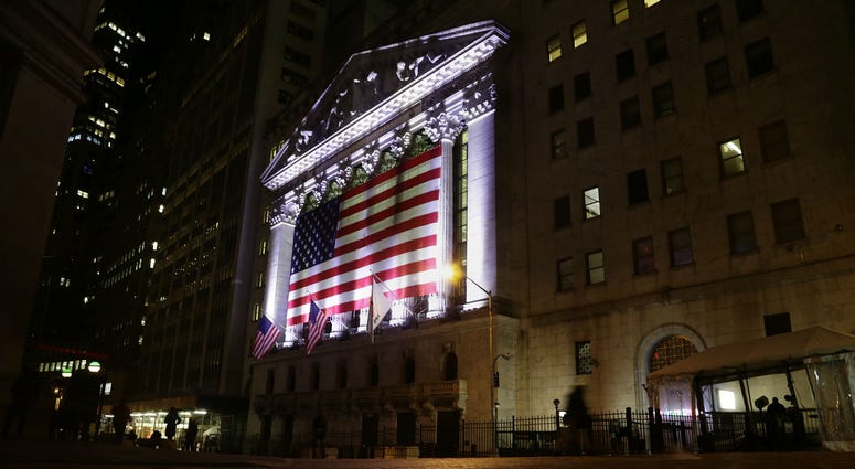 FILE- In this Feb. 17, 2017, file photo, an American flag hangs on the front of the New York Stock Exchange in New York. FILE- In this Feb. 17, 2017, file photo, an American flag hangs on the front of the New York Stock Exchange in New York.