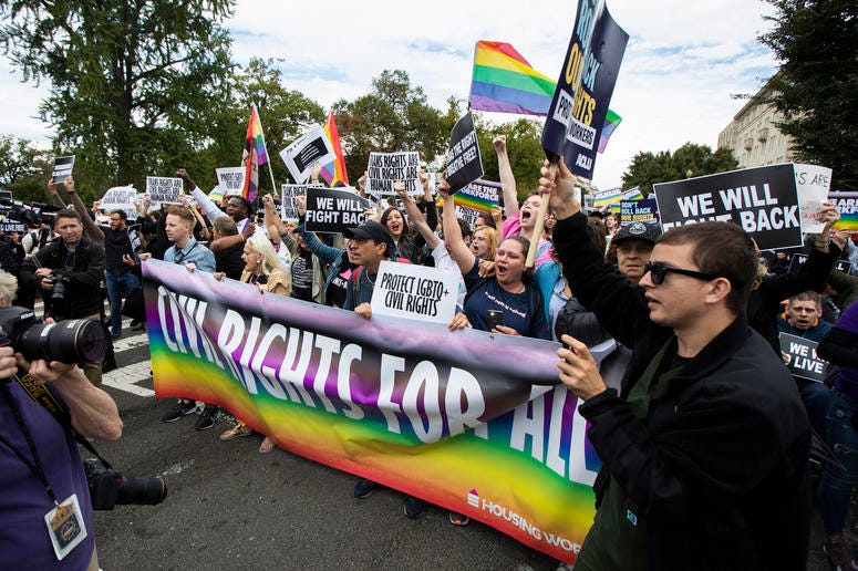Supporters of LGBT rights stage a protest on the street in front of the U.S. Supreme Court, Tuesday, Oct. 8, 2019, in Washington. LGBT rights