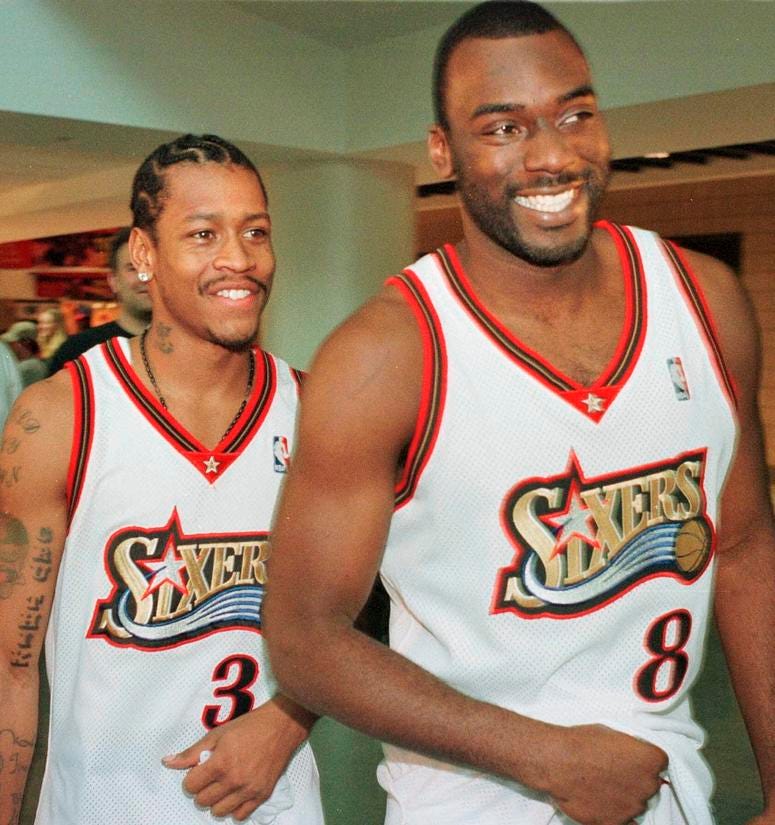 In this Oct. 4, 1999, file photo, Philadelphia 76ers' Allen Iverson (3) and teammate Aaron McKie (8) smile as they enter an NBA basketball news conference during the team's media day in Philadelphia. Aaron McKie plays for 76ers in 1999