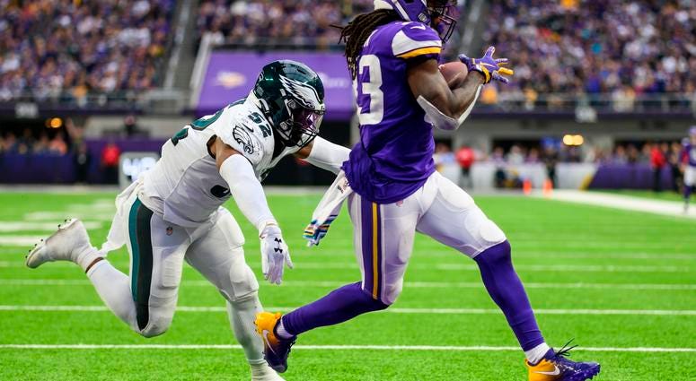 Dalvin Cook #33 of the Minnesota Vikings runs with the ball away from #52 Zach Brown for a one-yard touchdown in the fourth quarter of the game against the Philadelphia Eagles at U.S. Bank Stadium on Oct. 13, 2019 in Minneapolis, Minnesota. Eagles vs. Vikings