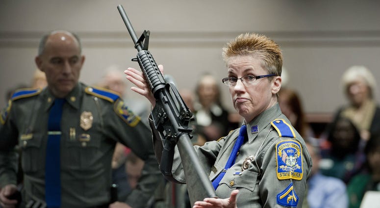 In this Jan. 28, 2013, file photo, firearms training unit Detective Barbara J. Mattson, of the Connecticut State Police, holds a Bushmaster AR-15 rifle. In this Jan. 28, 2013, file photo, firearms training unit Detective Barbara J. Mattson, of the Connecticut State Police, holds a Bushmaster AR-15 rifle.