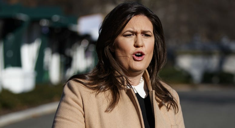 White House press secretary Sarah Huckabee Sanders talks with reporters outside the White House, Tuesday, Dec. 18, 2018, in Washington. White House press secretary Sarah Huckabee Sanders talks with reporters outside the White House, Tuesday, Dec. 18, 2018, in Washington.