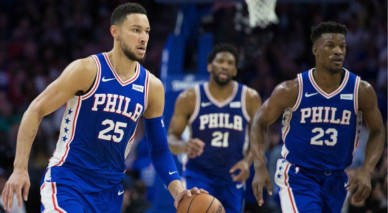 Philadelphia 76ers guard Ben Simmons (25) dribbles up court in front of guard Jimmy Butler (23) and center Joel Embiid (21) during the second quarter against the Boston Celtics at Wells Fargo Center. Philadelphia 76ers guard Ben Simmons (25) dribbles up court in front of guard Jimmy Butler (23) and center Joel Embiid (21) during the second quarter against the Boston Celtics at Wells Fargo Center.