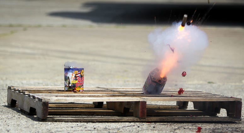 Fireworks tip over and explode during a safety demonstration at the Illinois Fire Safety Alliance building in Mount Prospect, Illinois, July 3, 2012. Fireworks safety demonstration