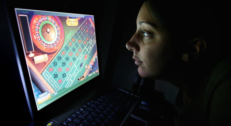 A woman using an internet gambling website to play online roulette. A woman using an internet gambling website to play online roulette.