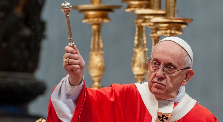Pope Francis blesses the faithful with holy water, as he celebrates the Mass of the Solemnity of Pentecost in St. Peter's Basilica in the Vatican. Pope Francis