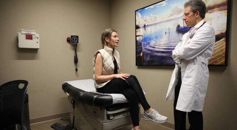 Alex Lickerman, founder and CEO of ImagineMD, examines patient Emily Golin at the ImagineMD office in downtown Chicago on June 12, 2018. Alex Lickerman, founder and CEO of ImagineMD, examines patient Emily Golin at the ImagineMD office in downtown Chicago on June 12, 2018.