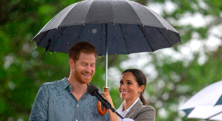 10/17/2018 - The Duchess of Sussex holds an umbrella as the Duke of Sussex makes a speech at a community picnic in Victoria Park in Dubbo, New South Wales, on the second day of the royal couple's visit to Australia. 10/17/2018 - The Duchess of Sussex holds an umbrella as the Duke of Sussex makes a speech at a community picnic in Victoria Park in Dubbo, New South Wales, on the second day of the royal couple's visit to Australia.