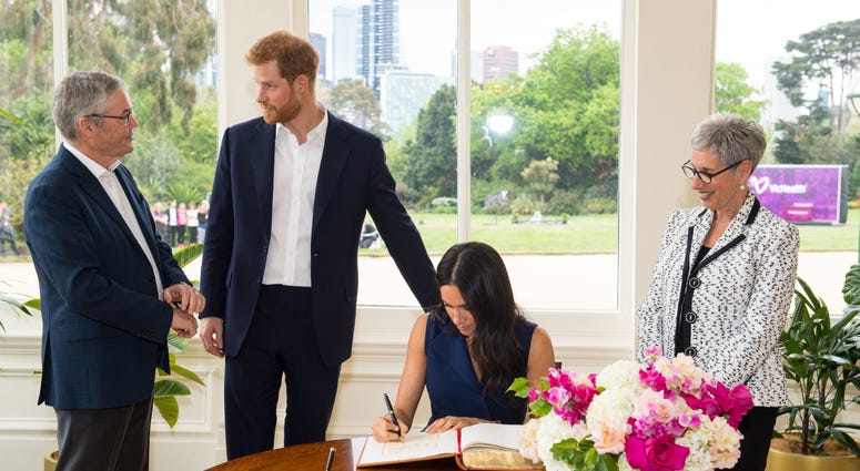 10/19/2018 - The Duke and Duchess of Sussex sign the visitor book at Government House, alongside Governor of Victoria Linda Dessau (right) and her husband Anthony Howard (left) at a reception given by the Governor of Victoria, at Government House. 10/19/2018 - The Duke and Duchess of Sussex sign the visitor book at Government House, alongside Governor of Victoria Linda Dessau (right) and her husband Anthony Howard (left) at a reception given by the Governor of Victoria, at Government House.