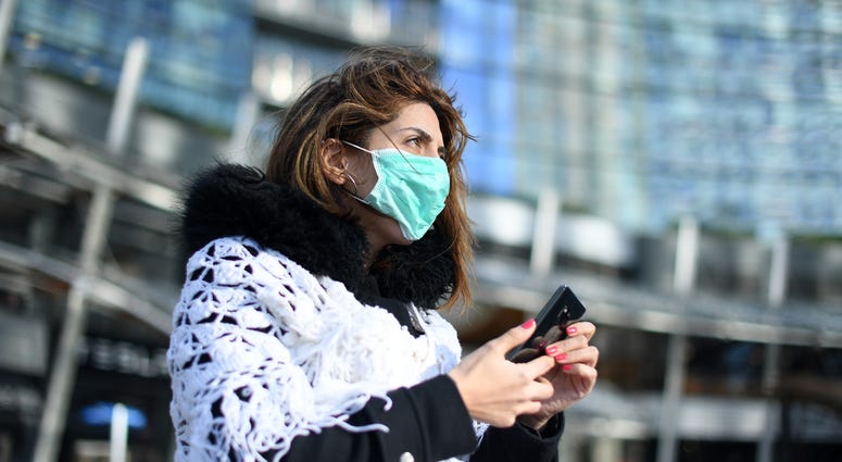 A woman wears a face mask in Milan, Italy, Feb. 26, 2020. A woman wears a face mask in Milan, Italy, Feb. 26, 2020.
