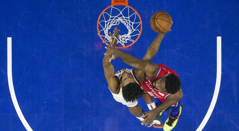Cleveland Cavaliers' Collin Sexton, left, shoots against Philadelphia 76ers' Joel Embiid, right, of Cameroon, during the first half of an NBA basketball game, Tuesday, March 12, 2019, in Philadelphia. Cleveland Cavaliers' Collin Sexton, left, shoots against Philadelphia 76ers' Joel Embiid, right, of Cameroon, during the first half of an NBA basketball game, Tuesday, March 12, 2019, in Philadelphia.
