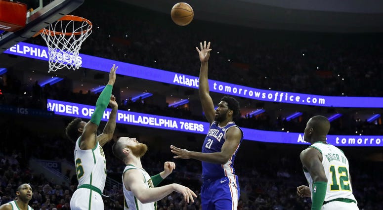 Philadelphia 76ers' Joel Embiid (21) shoots as Boston Celtics' Terry Rozier, from right, Aron Baynes, Marcus Smart and Al Horford watch during the first half of an NBA basketball game, Wednesday, March 20, 2019, in Philadelphia. Philadelphia 76ers' Joel Embiid (21) shoots as Boston Celtics' Terry Rozier, from right, Aron Baynes, Marcus Smart and Al Horford watch during the first half of an NBA basketball game, Wednesday, March 20, 2019, in Philadelphia.