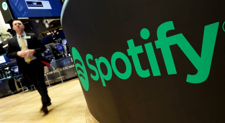 In this Tuesday, April 3, 2018 file photo, a trading post sports the Spotify logo on the floor of the New York Stock Exchange. In this Tuesday, April 3, 2018 file photo, a trading post sports the Spotify logo on the floor of the New York Stock Exchange.