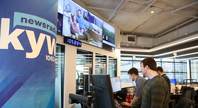 News production assistant Phillip Casey, editor Tim McLaughlin, and writer Conner Barkon man the new KYW Newsradio editor's desk at 2400 Market.