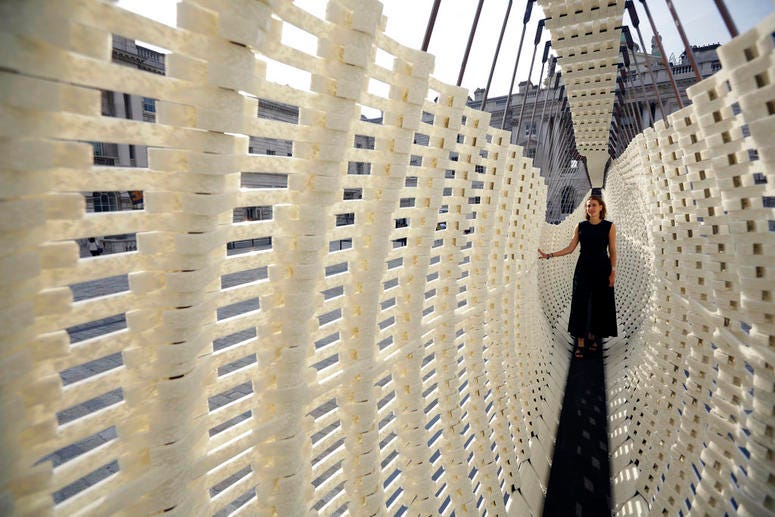 The Greek exhibit "Disobedience", with designer Nassia Inglessis posing, a 17 metre-long wall constructed from a steel spring skeleton built up with recycled plastic which flexes, is displayed during a preview for the London Design Biennale. The Greek exhibit "Disobedience", with designer Nassia Inglessis posing, a 17 metre-long wall constructed from a steel spring skeleton built up with recycled plastic which flexes, is displayed during a preview for the London Design Biennale.