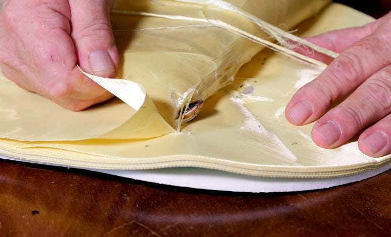 Steve Naremore, founder and CEO of TuffyPacks, disassembles one of his bulletproof panels to retrieve the nine flattened rounds that he fired from his Glock handgun, which were absorbed between the layers of the Aramid fiber ballistic material. Bullet-resistant backpacks