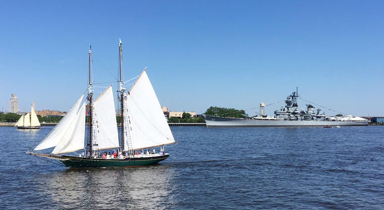 The battleship USS New Jersey, seen in the background, fired off rounds during the Parade of Sail. The battleship USS New Jersey, seen in the background, fired off rounds during the Parade of Sail.