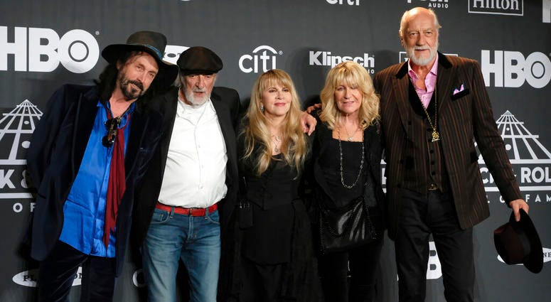 This March 29, 2019 file photo shows Inductee Stevie Nicks, center, posing with other members of Fleetwood Mac, from left, Mike Campbell, John McVie, Christine McVie and Mick Fleetwood at the Rock & Roll Hall of Fame induction ceremony in New York. Fleetwood Mac