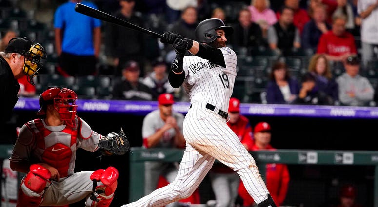 Colorado Rockies' Charlie Blackmon watches his walk-off home run against the Philadelphia Phillies during the 12th inning of a baseball game Friday, April 19, 2019, in Denver. Charlie Blackmon