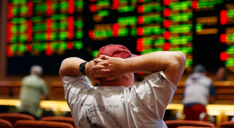A man watches a baseball game in the sports book at the South Point hotel-casino in Las Vegas. A man watches a baseball game in the sports book at the South Point hotel-casino in Las Vegas.