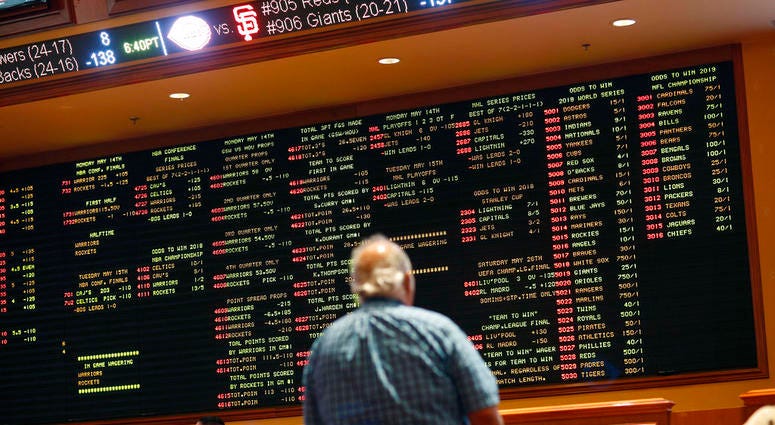 Betting odds are displayed on a board in the sports book at the South Point hotel and casino in Las Vegas. Betting odds are displayed on a board in the sports book at the South Point hotel and casino in Las Vegas.