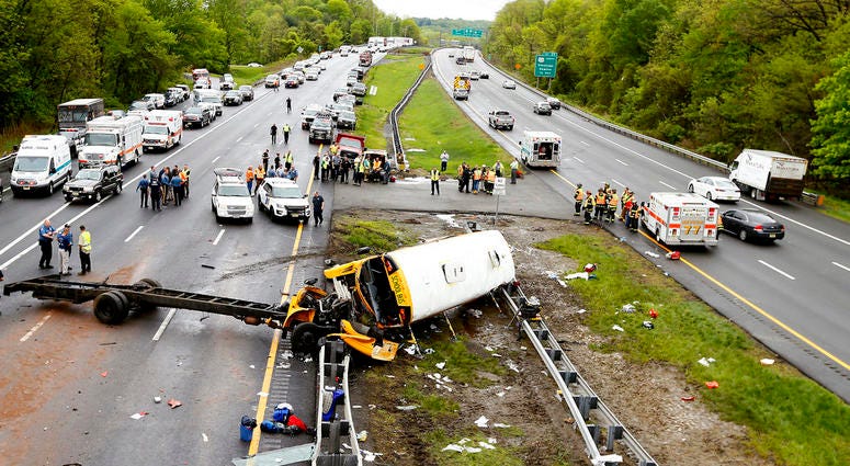 Emergency personnel examine a school bus after it collided with a dump truck, injuring multiple people, on Interstate 80 in Mount Olive, N.J. Emergency personnel examine a school bus after it collided with a dump truck, injuring multiple people, on Interstate 80 in Mount Olive, N.J.