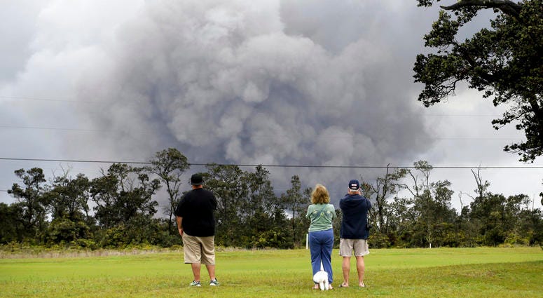 People watch as ash rises from the summit crater of Kilauea volcano. People watch as ash rises from the summit crater of Kilauea volcano.
