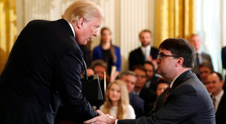 President Donald Trump shakes hands with Acting Veterans Affairs Secretary Robert Wilkie, during an event on prison reform in the East Room of the White House. Acting Veterans Affairs Secretary Robert Wilkie
