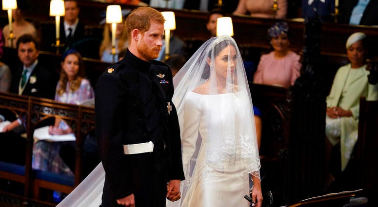 Britain's Prince Harry and Meghan Markle stand, prior to the start of their wedding ceremony, at St. George's Chapel in Windsor Castle in Windsor, near London, England, Saturday, May 19, 2018. Royal Wedding