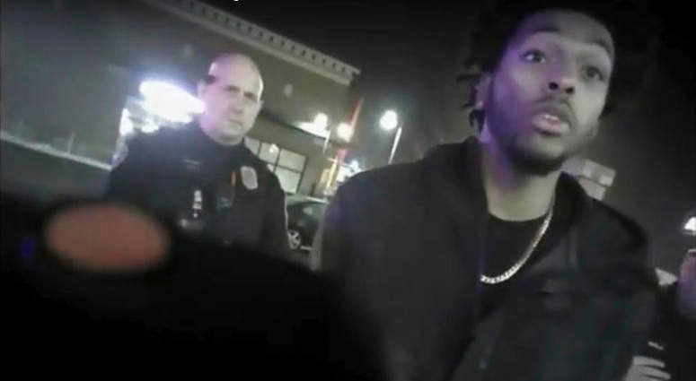 NBA Bucks guard Sterling Brown talks to arresting police officers after being shot by a stun gun in a Walgreens parking lot in Milwaukee. Sterling Brown