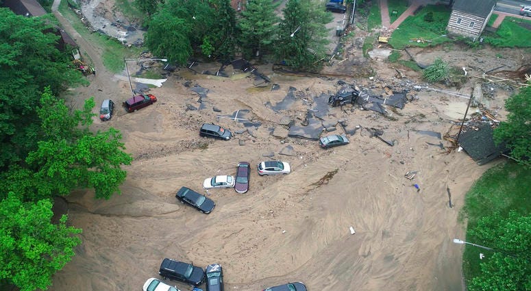 Vehicles swept by floodwater near the intersection of Ellicott Mills Drive and Main Street in Ellicott City, Md. Vehicles swept by floodwater near the intersection of Ellicott Mills Drive and Main Street in Ellicott City, Md.