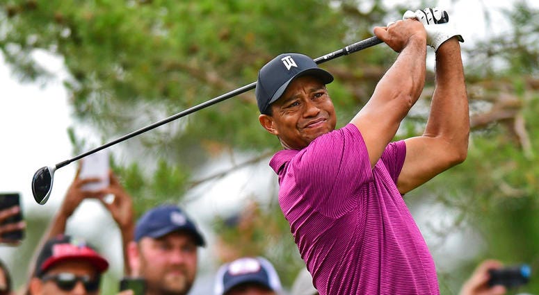 Tiger Woods follows through on his swing from the rough on the tenth hole during the pro-am for the the Memorial golf tournament. Tiger Woods follows through on his swing from the rough on the tenth hole during the pro-am for the the Memorial golf tournament.