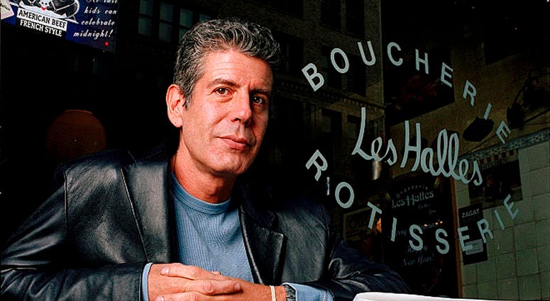 This Dec. 19, 2001 file photo shows Anthony Bourdain, the owner and chef of Les Halles restaurant, sitting at one of the tables in New York. Anthony Bourdain