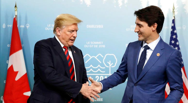 U.S. President Donald Trump shakes hands with Canadian Prime Minister Justin Trudeau during a meeting at the G-7 summit, Friday, June 8, 2018, in Charlevoix, Canada. G7 Summit