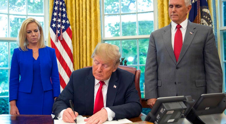 President Donald Trump signs an executive order to keep families together at the border, but says that the 'zero-tolerance' prosecution policy will continue, during an event in the Oval Office of the White House. President Donald Trump signs an executive order to keep families together at the border, but says that the 'zero-tolerance' prosecution policy will continue, during an event in the Oval Office of the White House.