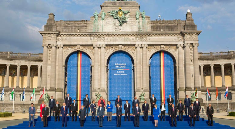 In this July 11, 2018, photo, President Donald Trump on stage during a group photo of NATO heads of state and government at Park Cinquantenaire in Brussels, Belgium. In this July 11, 2018, photo, President Donald Trump on stage during a group photo of NATO heads of state and government at Park Cinquantenaire in Brussels, Belgium.