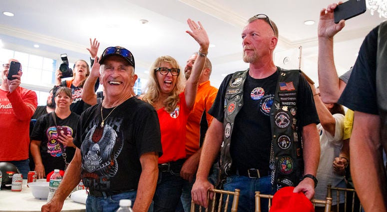 Supporters and members of Bikers for Trump wave and cheer, Saturday, Aug. 11, 2018, in the ballroom of Trump National Golf Club in Bedminster, N.J, during a meeting with President Donald Trump. Supporters and members of Bikers for Trump wave and cheer, Saturday, Aug. 11, 2018, in the ballroom of Trump National Golf Club in Bedminster, N.J, during a meeting with President Donald Trump.