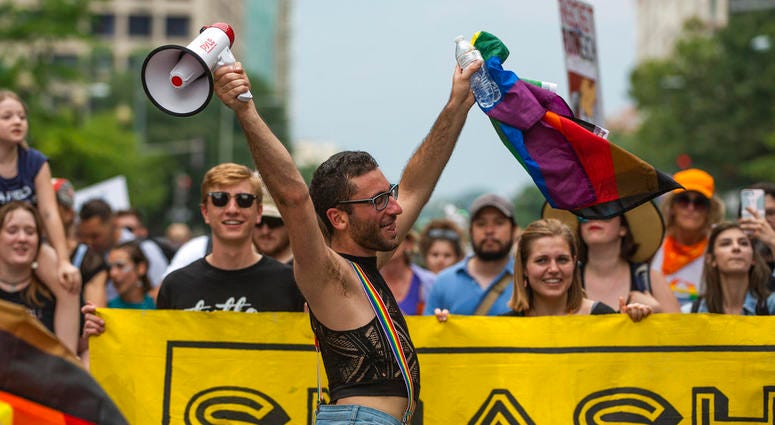 A man dances at the front of a counter-protest march on Pennsylvania Avenue towards the "Unite the Right 2" rally in Washington, Sunday, Aug. 12, 2018. A man dances at the front of a counter-protest march on Pennsylvania Avenue towards the "Unite the Right 2" rally in Washington, Sunday, Aug. 12, 2018.
