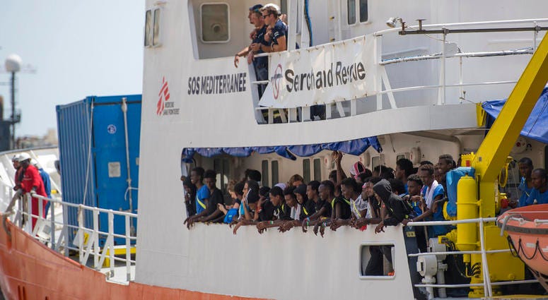 Migrants and members of the crew of the Aquarius rescue ship wave as they enter the harbor of Senglea, Malta, Wednesday, Aug. 15, 2018. Migrants and members of the crew of the Aquarius rescue ship wave as they enter the harbor of Senglea, Malta, Wednesday, Aug. 15, 2018.