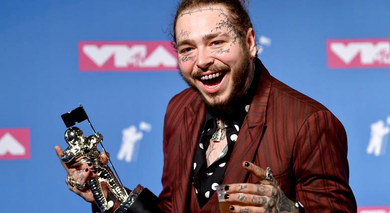 Post Malone poses with the award for song of the year for "Rockstar" in the press room at the MTV Video Music Awards at Radio City Music Hall on Monday, Aug. 20, 2018, in New York. Post Malone